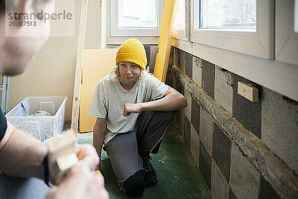 Boy helping father in renovation at home