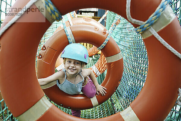 Smiling girl doing obstacle course at rope park