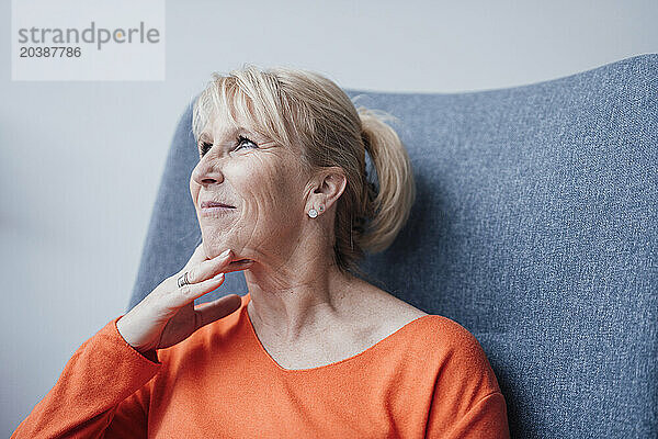 Smiling blond businesswoman sitting in chair