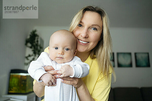 Happy blond mother with son at home