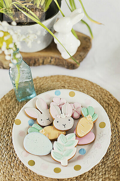 Easter cookies in plate over rattan on table
