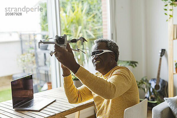 Senior man wearing smartglasses learning to operate drone