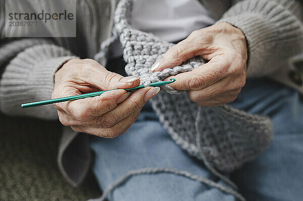 Senior woman knitting at home