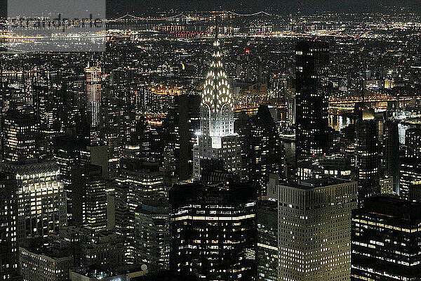 USA. New York City. Manhattan. Empire State Building. View from the top of the building at dusk and night. View of the Chrysler Building and the north east of midtown Manhattan.