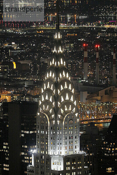 USA. New York City. Manhattan. Empire State Building. View from the top of the building at dusk and night. View of the Chrysler Building and the north east of midtown Manhattan.