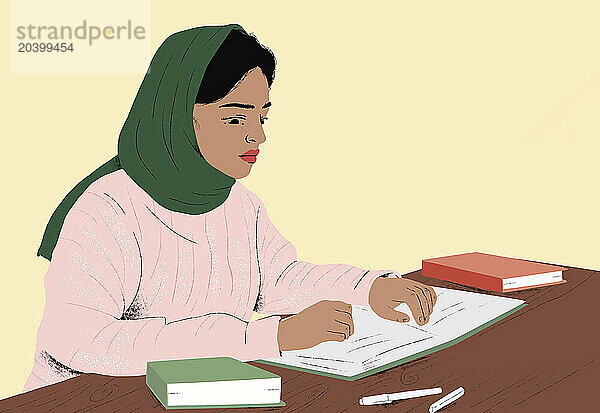 Woman wearing hijab studying at table against yellow background