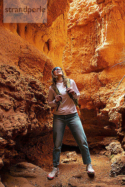 Mature woman looking up in red canyon