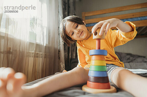 Cute boy playing with educational game at home