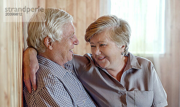 Smiling elderly couple spending leisure time at home