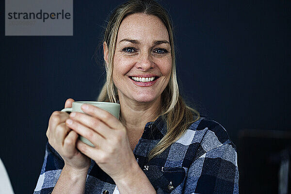 Smiling mature woman with coffee cup