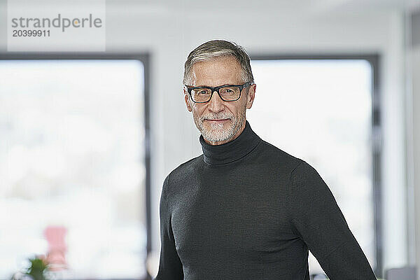 Portrait of confident senior businessman in office