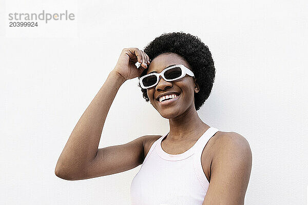 Happy woman with head in hand against white background