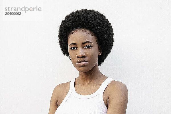 Young Afro woman against white background