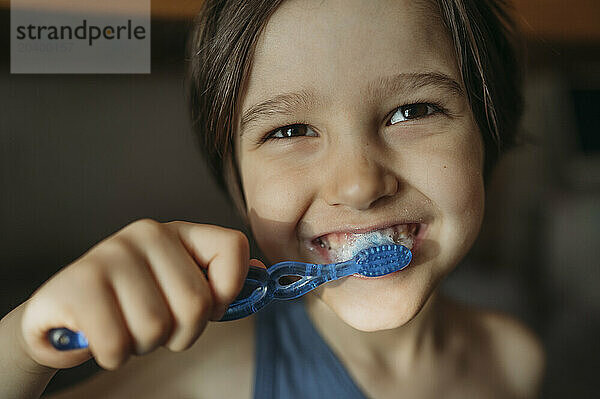 Boy brushing teeth at home