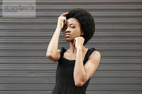 Young woman posing in front of shutter