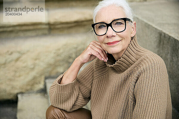 Smiling senior woman in beige sweater