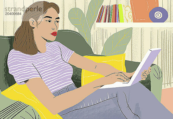 Relaxed businesswoman using laptop sitting on sofa working at home