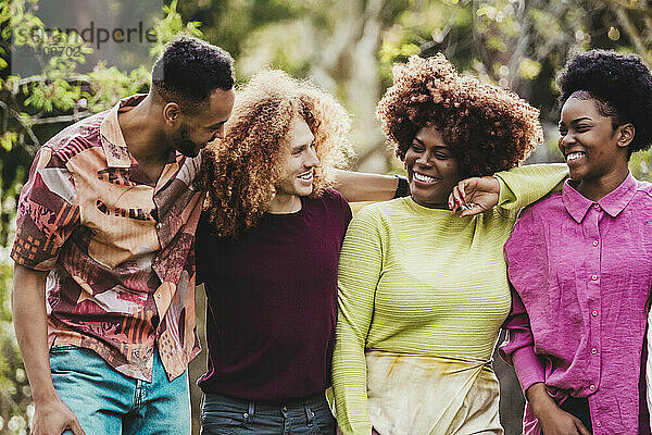 Happy multiracial friends having fun at park