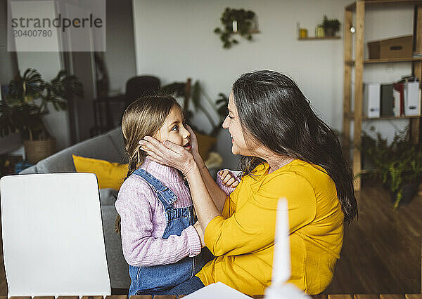 Loving grandmother with granddaughter at home