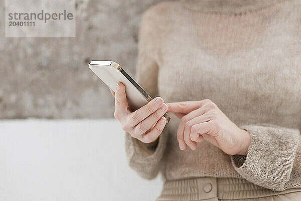 Hands of woman using smart phone