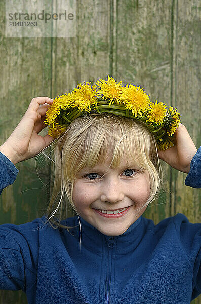 Smiling girl wearing dandelions tiara