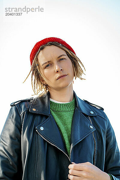 Confident young woman wearing leather jacket