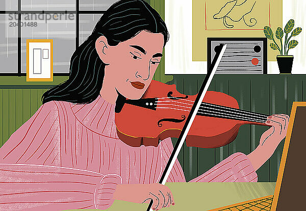 Woman learning violin through online tutorial at home