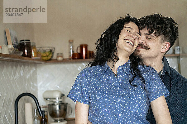 Romantic couple having fun in kitchen at home