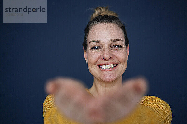 Smiling beautiful woman against colored background