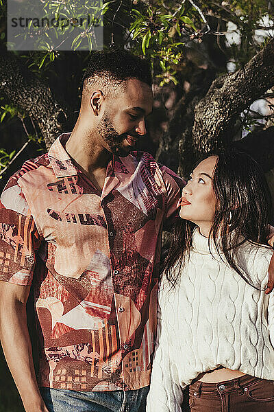 Romantic couple looking at each other in park