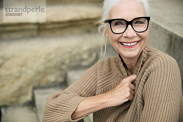 Happy senior woman in beige sweater