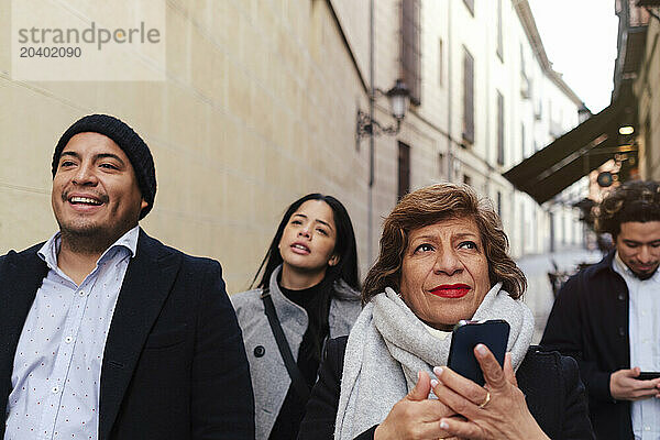 Happy family walking together in front of buildings at vacations