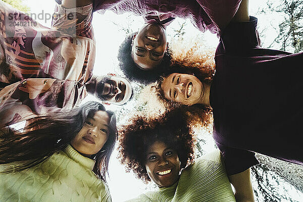 Playful multiracial friends enjoying at park