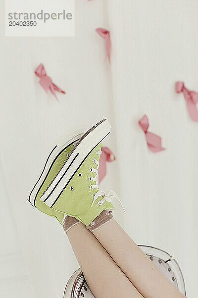 Girl wearing green canvas shoes