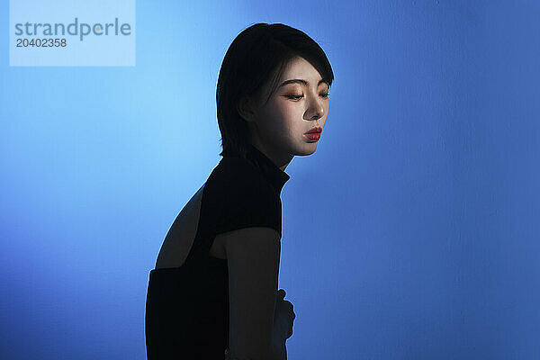 Young woman against blue background