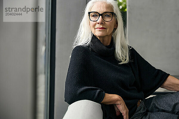 Elderly woman with white hair at home