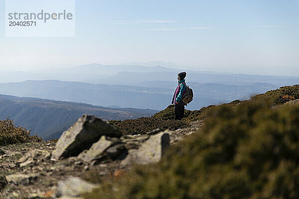 Young explorer standing on mountain