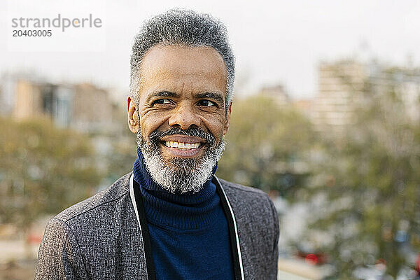 Happy mature businessman with gray hair and beard