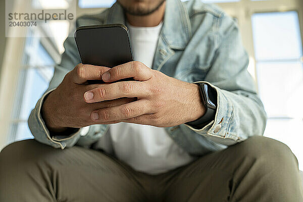 Man using mobile phone at home