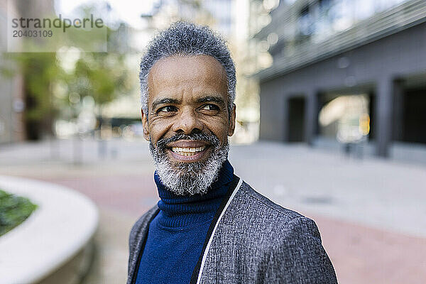 Smiling mature businessman at office park