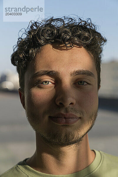 Young man with sunlight over face