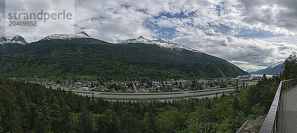 Cruise ships are seen docked at the Port of Skagway in southern Alaska. Large mountains adorn the landscape and make a scene that is magnificent to behold.