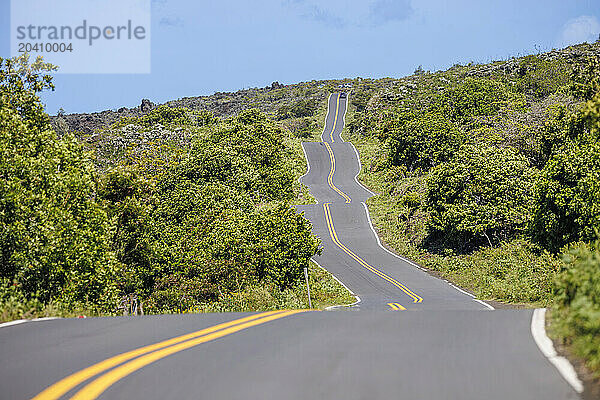 Often referred to as The Back Side of Hana or Kaupo  the road cuts a zigzag course in sections through a rough  often dry  arid landscape with Hawaiian Homesteads  cattle ranches  open spaces  spectacular coastal and mountain views as well as recent lava flows.