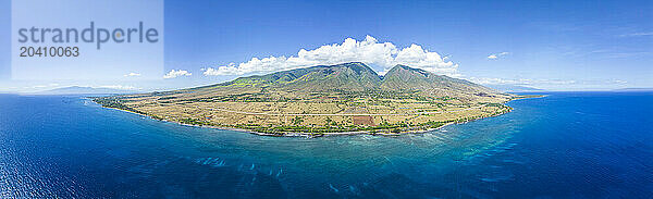 An aerial view of the West Maui Mountains looking into Launiupoko and the valley behind  Maui  Hawaii  USA. The island of Molokai is on the horizon past the town of Lahaina.