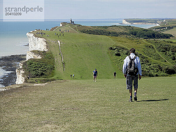 Beachy Head coast path with Belle Tout Lighthouse and the Seven Sisters Cliff in the background  Beachy Head  East Sussex  UK © Renzo Frontoni