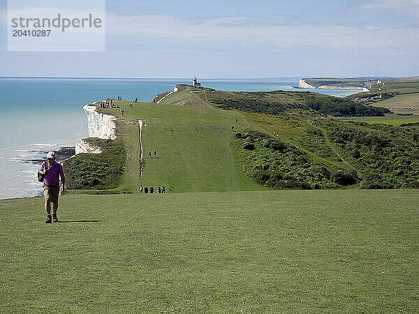 Beachy Head coast path with Belle Tout Lighthouse and the Seven Sisters Cliff in the background  Beachy Head  East Sussex  UK © Renzo Frontoni