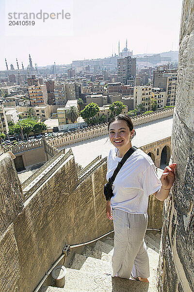 Gan 15483  Young female tourist ascending the minaret Mosque of Ibn Tulun largest in Cairo Egypt and one of the oldest