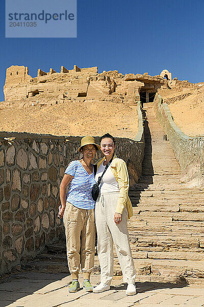 GAN 15482  Gan 15483  female tourists ascending to the tombs of the Nobles  Aswan Egypt