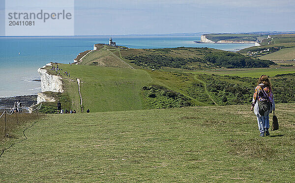 Beachy Head coast path with Belle Tout Lighthouse and the Seven Sisters Cliff in the background  Beachy Head  East Sussex  UK © Renzo Frontoni