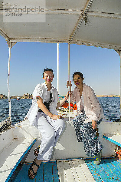 GAN 15482  Gan 15483 Tourist boat transporting female tourists cruising the river Nile to Philae temple near Aswan  Egypt